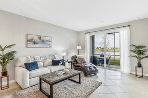 The living room with a lake & golf course view