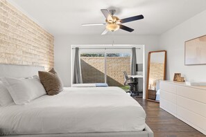 Primary bedroom - 1 king bed, 1 twin bed, standing desk with monitor