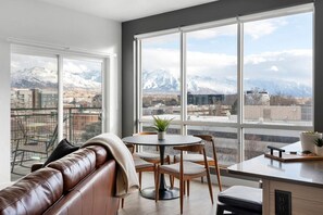 Enjoy dramatic views of the majestic Wasatch Mountains through floor-to-ceiling windows in the living room.