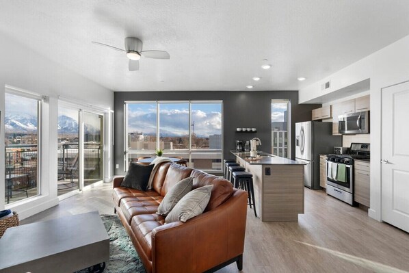 Soak in the breathtaking panoramic views of the Wasatch Mountains from the floor to ceiling living room windows.