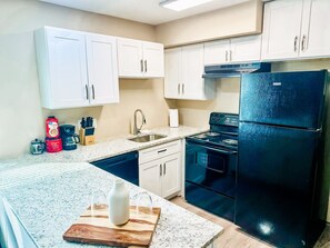 Step into the full kitchen, equipped with appliances, perfect for preparing your favourite home-cooked meals during your stay.