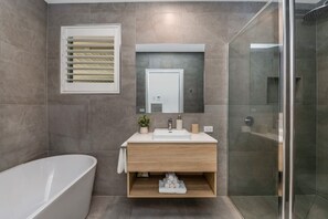 Bathroom complete with bath, walk in shower and beautiful vanity.