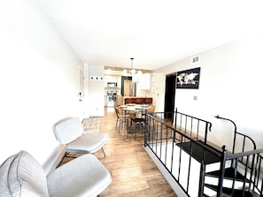 Bright and inviting second-floor condo featuring an open kitchen and dining area, perfect for gathering and sharing meals. Enjoy seamless flow and ample space for relaxation and entertaining!
