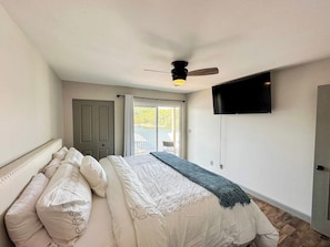 This bedroom has a king size bed, TV, and a spectacular lake views from the balcony