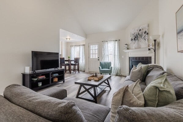 Spacious living room with high ceilings and lots of natrual light.