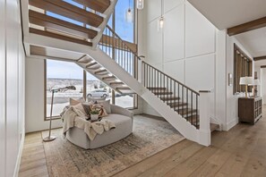 grand staircase off the entry way and kitchen