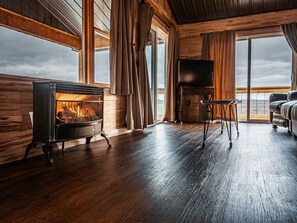 Upstairs/Main Floor Living room with gas logs and Smart TV - views out the windows