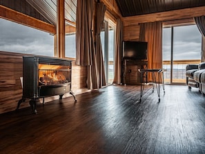 Upstairs/Main Floor Living room with gas logs and Smart TV - views out the windows