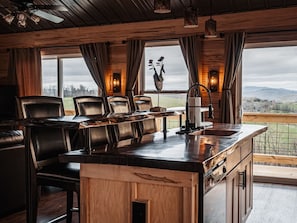 Upstairs/Main Floor Dining Area/Bar in Kitchen and views out the windows