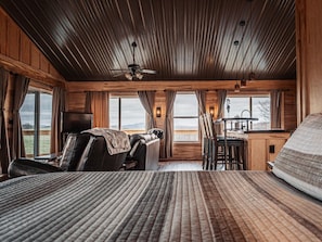 Upstairs/Main Floor looking at living room and dining area from king bed and views out windows