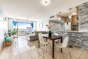 Dining area w/ 4 chairs plus breakfast bar w/ 2 adjustable stools
