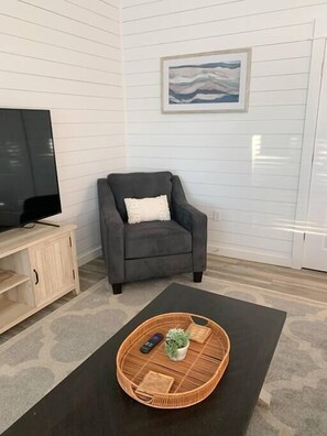 Cozy armchair in the living room, perfect for sipping your morning coffee and unwinding.