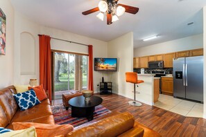 Living room showing TV, Breakfast Bar, and seating areas