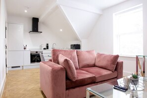 Living area with a super comfy sofa and kitchen.