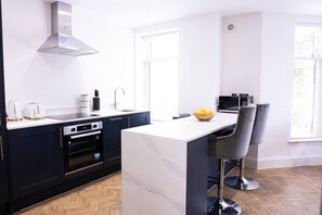 Kitchen and island for cooking and eating.  Finished with granite worktops.

Kitchen fully equipped with oven, hob, fridge freezer, washing machine, dishwasher and microwave.