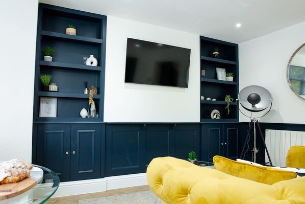 Beautifully designed living area with large 55 inch smart tv and streaming services.