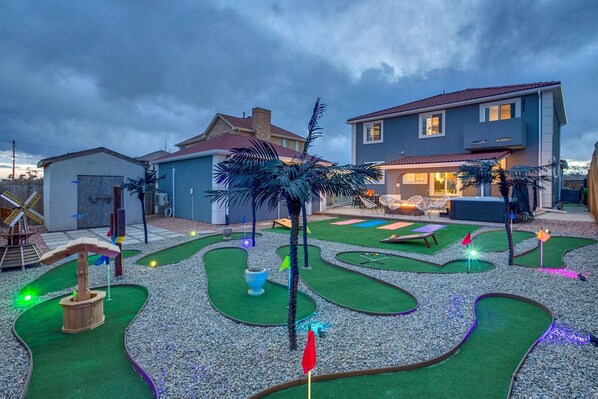 Putt Putt featuring stylish palm trees, a cactus, a wishing well, and windmill!