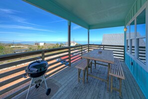 Upper deck features an outdoor dining table and grill for evening BBQs!