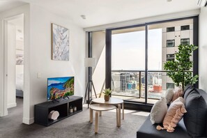 The living area with a 3-seater sofa bed.