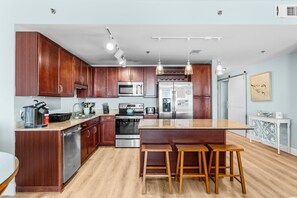 Enjoy a spacious, fully equipped kitchen with modern appliances and a large island, perfect for cooking and entertaining during your stay.