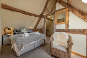 Bedroom one with a 5' king-size bed, exposed timbers and en-suite shower room