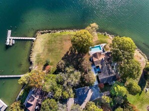 A bird's eye view of Topside! This two acre waterfront property beckons you to unwind, recharge, and spend time with loved ones.