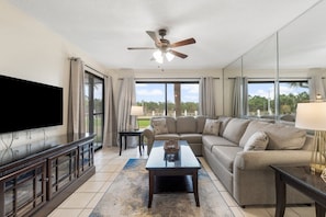 Living Area with Golf Course View, Flat Screen TV, Sleeper Sofa, and Private Balcony Access