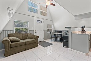 A cozy sofa next to the dining table