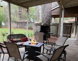 Enjoy a good conversation around our propane gas fire pit on the large back patio.