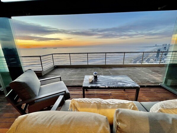 The expansive deck over looks the beach and ocean. North facing sunlight, yet protected from the wind... this is the beauty of outside living!