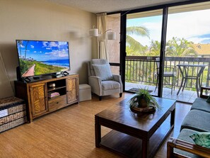 The living room also has a comfortable recliner and large TV.