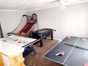 Game room with older dual basketball, air hockey, foosball, small Ping-Pong...