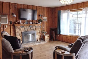 Living room. Has couch, reclinable love seat, fireplace, smart TV and cable.