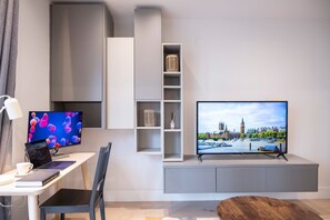 Integrated living, bedroom, and kitchen spaces in an open layout.