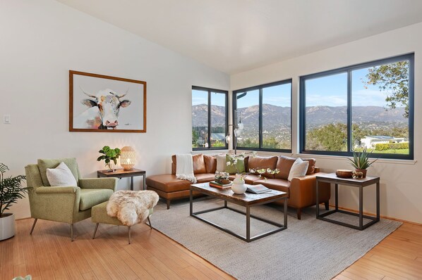Charming living room offers stunning mountain and ocean views