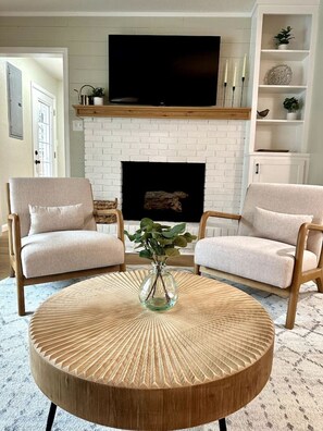 Living room's stylish, modern furniture and decor (fireplace is nonfunctional)