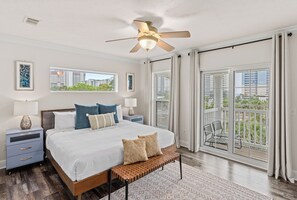 Primary bedroom features a king bed, balcony, TV, and ensuite bathroom.