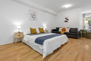 A bedroom area with a King sized bed & plush pillows.