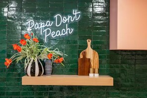 Peach themed neon sign in kitchen
