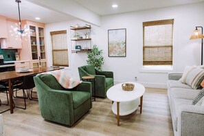 Open-concept living area w/ sleeper couch (Queen bed) and smart TV