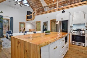 The kitchen, living room, and loft above.