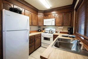 Kitchen equipped with full-size Appliances.