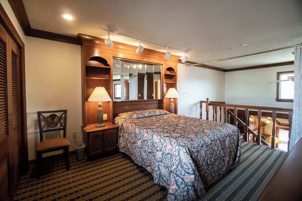 The upstairs bedroom has an open view of the ground floor.