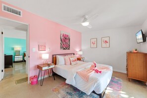 The Pink Room with queen size bed, TV & also has double doors to outside.