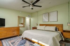 Stylish mid-century modern design continues in Bedroom 2 with a king-size bed and smart TV