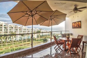 Common terrace area with table and sun umbrellas