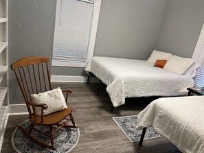 Room with two queen beds. Room for instruments in cases under beds