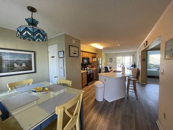 Entrance to condo, dining area, kitchen, living room, entrance to 2nd bedroom
