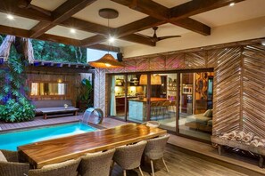 Outdoor dining area integrated with the patio and the interior of the house. Decorated in natural tones and wood