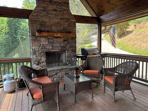 screened porched with wood fireolace
